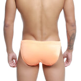 MetroMaleWear vanguard swim bikini neon orange featuring sleek peach-colored form-fitting fabric and snug waistband