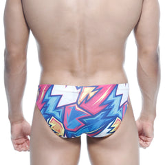 Metro malewear vasco hip brief atractiv0 5103-33 swim trunks with vibrant pink blue and yellow lightning bolt patterns on white