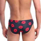 Black swim trunks by metromalewear featuring a bold red lipstick print for stylish beachwear use