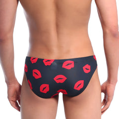 Black swim trunks by metromalewear featuring a bold red lipstick print for stylish beachwear use