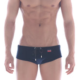 Navy blue velvet swim briefs by MetroMaleWear with black drawstring and red brand tag on the waistband