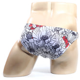 White swim trunks by metromalewear featuring bold floral pattern with black outlines and red accents for beachwear
