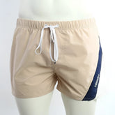 Beige and navy blue MetroMaleWear Viena athletic swim shorts with white drawstring waistband for active use