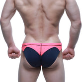 Bright pink and navy blue swim bikini by metromalewear with bold color-block design for vibrant beachwear