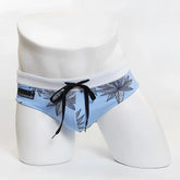 Miiw floral beach bikini swimwear light blue swim trunks with black leaf pattern white waistband and black drawstrings