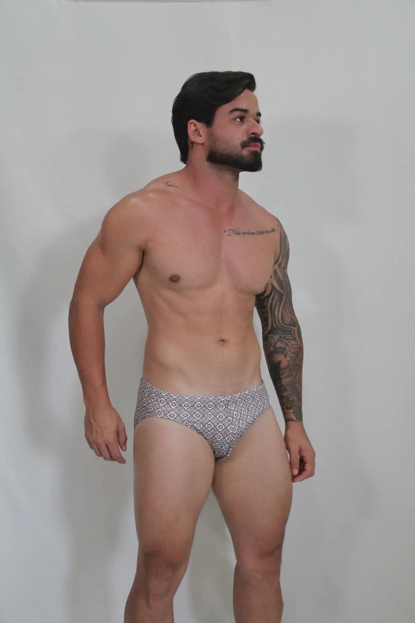 Patterned gray and white geometric mosaic swim brief designed for swimming and beachwear use