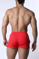 Red muzzle up athletic shorts with a ribbed texture and side pockets for comfortable sportswear use