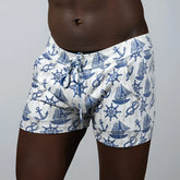 White nautical linen texture shorts with blue anchor sailboat and ship wheel pattern swim trunks