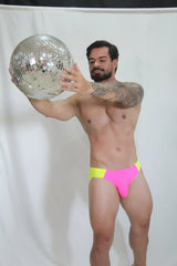 Shiny silver disco ball with mirrored facets reflecting light for vibrant neon curved swim brief display