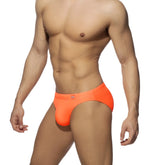 Neon swim bikini bright orange swim trunks with snug form-fitting design and small logo on waistband front view