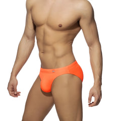 Neon swim bikini bright orange swim trunks with snug form-fitting design and small logo on waistband front view