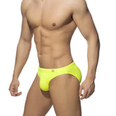 Bright neon yellow swim bikini trunks with sleek form-fitting design and small waistband logo for swimming use