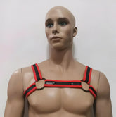 Red and black neoprene bulldog harness with leather straps and metal rings for secure dog restraint