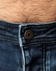Dark blue denim jeans np jean with metallic button featuring embossed text for a stylish casual look