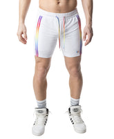 Model wearing Nasty Pig white rugby shorts with rainbow stripes and matching drawstrings.