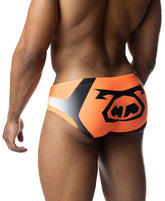 Rear view of a man wearing vibrant orange and black Nasty Pig hyper bikini swimwear with a large logo on the back.