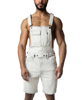 A muscular man wears bleached denim Nasty Pig overall shorts featuring a chest pocket and zipper.