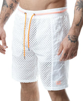A model wearing white Nasty Pig Hyper Classic mesh shorts with vibrant orange drawstrings and trim.