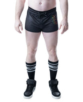 A model wearing black mesh Nasty Pig Pride Trunk Short 4.0 with a drawstring and a rainbow logo on the thigh.