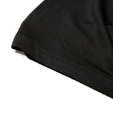 Black cotton t-shirt sleeve with neatly stitched hem on nylon active underwear tank top for comfortable support