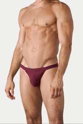 AWRY Menswear maroon Oaisis swim tanga worn by a male model against a light grey background.
