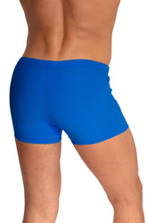Rear view of a man wearing solid blue Olaf Benz beachpants swimwear.