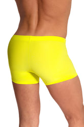Rear view of a man wearing solid yellow Olaf Benz Blu2550 beachpants swimwear against a white background.