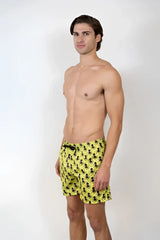 Bright yellow octopus print swim shorts featuring a repeating black octopus pattern for beachwear