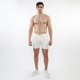 White parquet jacquard stretch knit shorts with a sleek minimalist design and a single black button at the waistband