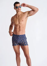 Peacock feathers seersucker swim shorts in blue with a pattern of orange and yellow ice cream cones and mesh lining