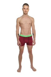 Performance yoga leggings short in brick red heather with a bright green elastic waistband shown from the front