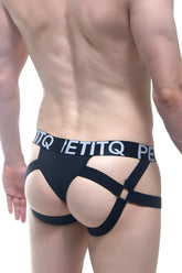 Black strappy men’s briefs with a bold petitq logo waistband in the PetitQ Jockstring Seyre Black design