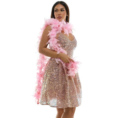 A rose gold sequined mini dress with a v-neckline and flared skirt paired with a soft pink feather boa with tinsel