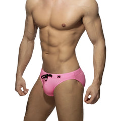 Bright pink pique speedo swim trunks with black drawstring and logo on waistband for swimming and beachwear