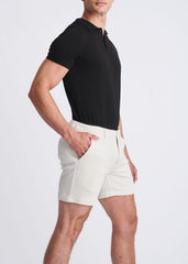 Cream-colored textured stretch knit chino shorts with a modern tailored cut and subtle side seam detailing