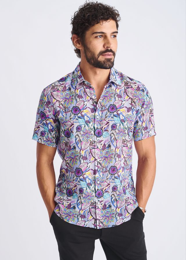 A lightweight linen tencel short-sleeved shirt with a purple blue and pink floral pattern on light lavender background