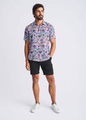 A man wearing a floral lightweight linen Tencel short-sleeved shirt in purple blue and pink