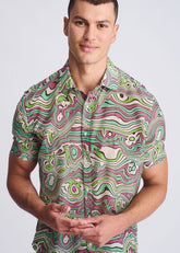 A vibrant short-sleeved button-up swirls lightweight cotton silk shirt with green pink and white psychedelic patterns