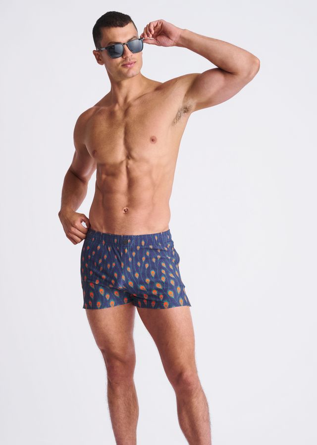 Peacock feathers seersucker swim shorts in blue with a pattern of orange and yellow ice cream cones and mesh lining