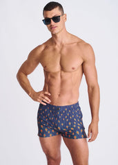 Blue seersucker swim shorts with mesh lining featuring orange and yellow peacock feather patterns