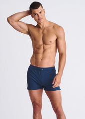 Navy blue riviera seersucker swim shorts with mesh lining and single button waistband closure for athletic use
