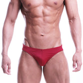 Red athletic briefs with smooth form-fitting design from metromalewear posingwear core posing suit terracotta collection