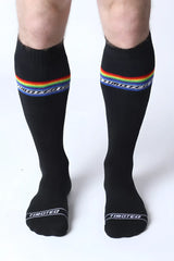 Black knee high socks with a rainbow stripe and tiboteo branding designed for pride and everyday wear