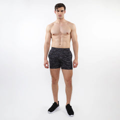 Black printed mesh stretch performance shorts with a subtle geometric leaf pattern made from lightweight fabric