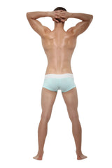 A man wearing reef blue private structure nexus trunk boxer briefs with a white waistband size large facing forward