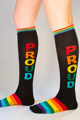 Black knee high socks with rainbow proud lettering vertically and matching rainbow striped cuff and toe