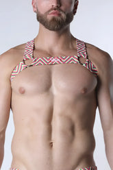 A man wearing a pulse elastic harness with vibrant pink green and white geometric zigzag stripes