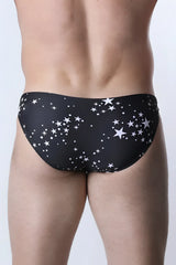 Pulse swim brief in black swim trunks with a white star and dot pattern for stylish swimwear use