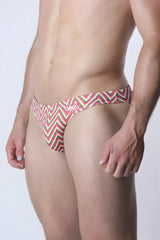 Vaux pulse swim brief men’s swim trunks with bold red green and white zigzag pattern for beach use