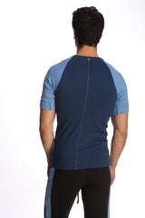 Back view of royal blue raglan virtual crew neck athletic shirt with light blue sleeves and central zipper down the back